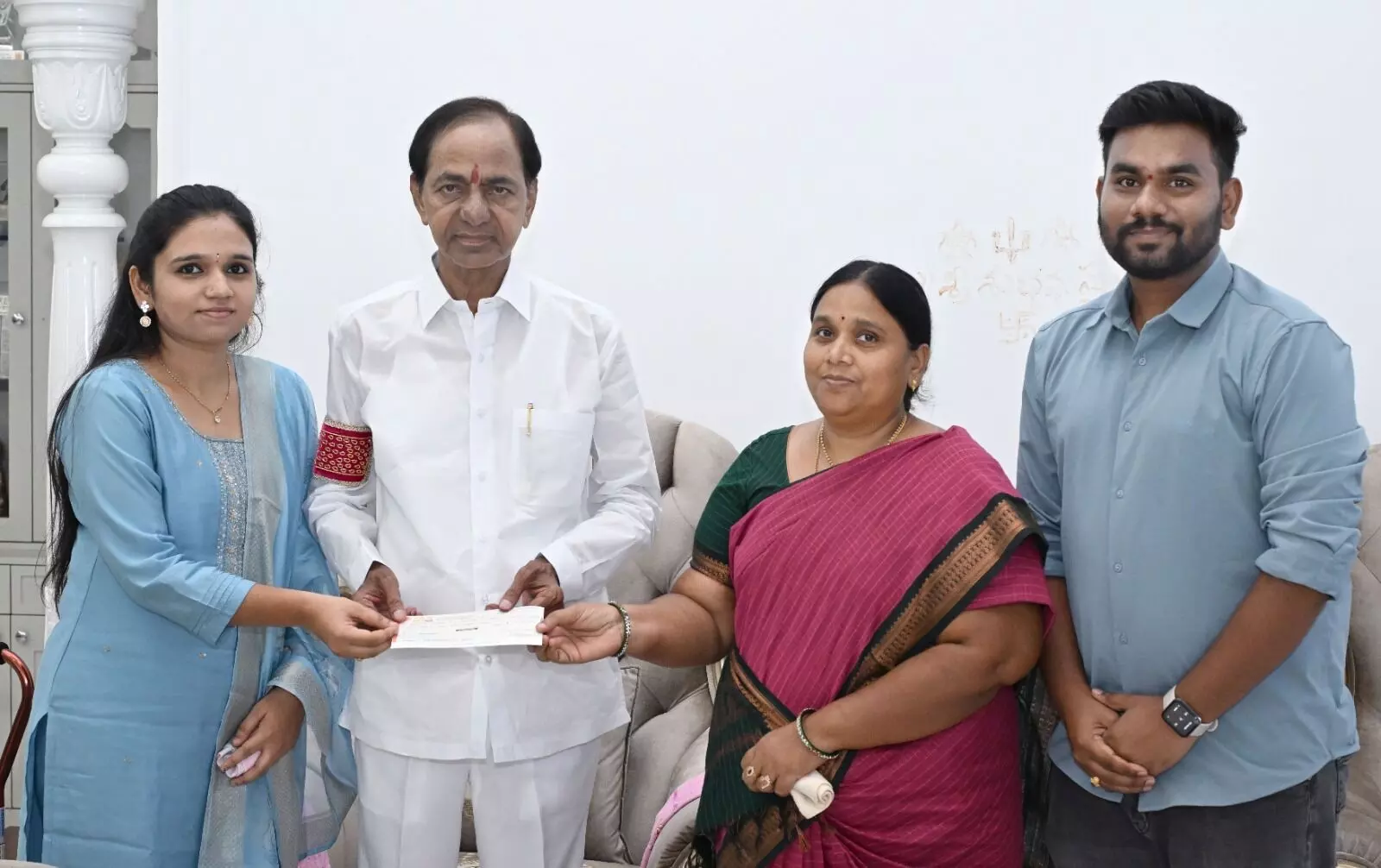 KCR hands over cheque for Rs 25 lakh for Telangana martyr constable Kishtaiahs daughters PG medical education