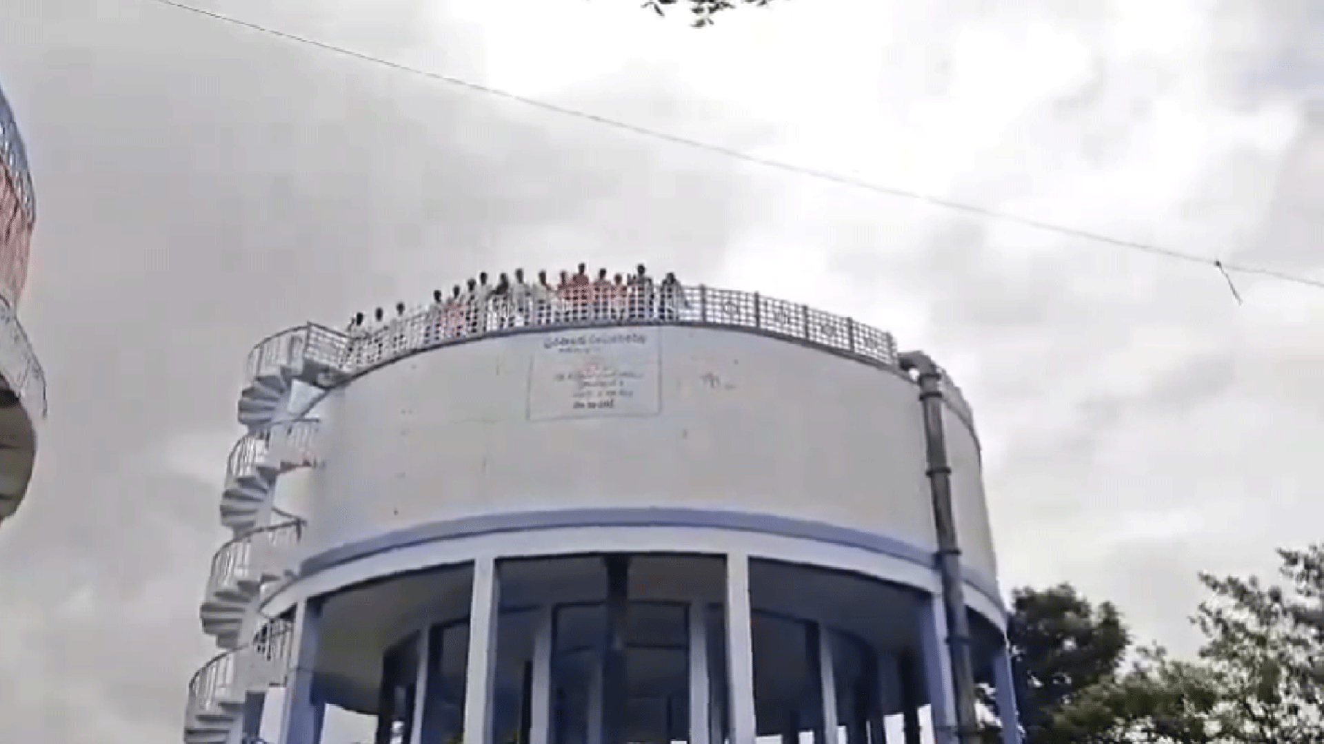 Ration dealer aspirants protest atop water tank in Sircilla, demand fair appointments